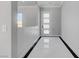 Bright entryway featuring sleek white tile flooring and a modern front door at 5601 Mary Lou St, Pahrump, NV 89061