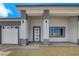 Stylish home exterior boasting a three-car garage and modern architectural details at 5601 Mary Lou St, Pahrump, NV 89061
