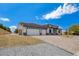 Beautiful home exterior featuring a three-car garage and a spacious driveway at 5601 Mary Lou St, Pahrump, NV 89061