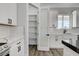 Close up of new kitchen features white cabinets, pantry and stainless appliances at 5601 Mary Lou St, Pahrump, NV 89061