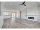 Spacious living room with a fireplace and modern ceiling fan, flowing into a well-equipped kitchen at 5601 Mary Lou St, Pahrump, NV 89061