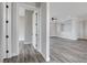 Open-concept living room featuring wood-look floors, gray walls, and bright lighting at 5601 Mary Lou St, Pahrump, NV 89061
