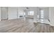 Spacious living room with wood-look floors and a cozy fireplace at 5601 Mary Lou St, Pahrump, NV 89061