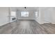 Open living area with wood-look floors, a fireplace, and large windows at 5601 Mary Lou St, Pahrump, NV 89061