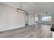 Bright living room featuring hardwood floors, modern lighting, and large windows for ample natural light at 5601 Mary Lou St, Pahrump, NV 89061