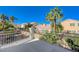 Balcony with decorative railing overlooking a fenced back yard with mature landscaping and blue skies at 5824 Farmhouse Ct, Las Vegas, NV 89141