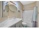 Well lit bathroom with a shower and tub combination with modern fixtures and oval mirror at 5824 Farmhouse Ct, Las Vegas, NV 89141