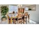 Dining room with a table set for six and a mirror and plants that add a touch of elegance at 5824 Farmhouse Ct, Las Vegas, NV 89141