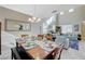 Open dining area with a table set for six and a view into a bright living room at 5824 Farmhouse Ct, Las Vegas, NV 89141