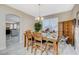 Well-lit dining room featuring a dining table with seating for four and a view of the kitchen at 5824 Farmhouse Ct, Las Vegas, NV 89141