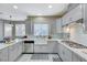 Well-lit kitchen featuring stainless appliances, modern cabinets, and a farm-style sink at 5824 Farmhouse Ct, Las Vegas, NV 89141