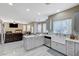 Bright kitchen features a central island, stainless appliances, and a farm-style sink at 5824 Farmhouse Ct, Las Vegas, NV 89141