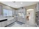 Modern kitchen with stainless appliances, light gray cabinets, and an open floorplan at 5824 Farmhouse Ct, Las Vegas, NV 89141