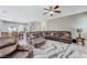 Expansive living room with tile floors, plush seating, and direct kitchen access at 5824 Farmhouse Ct, Las Vegas, NV 89141