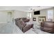 Spacious living room featuring a fireplace, large couch, and wood-style tile floors at 5824 Farmhouse Ct, Las Vegas, NV 89141