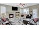 Cozy living room featuring a fireplace, large couch, and neutral paint colors at 5824 Farmhouse Ct, Las Vegas, NV 89141