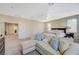 Spacious main bedroom with sitting area, ceiling fan, and carpet flooring and natural light at 5824 Farmhouse Ct, Las Vegas, NV 89141