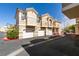 Exterior of townhomes shows multiple garages and stories, red-tile roof, and well kept landscaping at 5855 Valley Dr # 2020, North Las Vegas, NV 89031