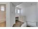 Well-lit hallway features neutral carpeting, access to a bathroom and stairs leading to upper level at 5855 Valley Dr # 2020, North Las Vegas, NV 89031