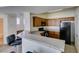 Open floorplan showing kitchen with wood cabinets and granite countertops at 5855 Valley Dr # 2020, North Las Vegas, NV 89031