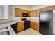 Kitchen featuring oak cabinets, granite countertops, and black appliances at 5855 Valley Dr # 2020, North Las Vegas, NV 89031