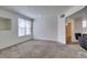 Spacious living room featuring carpet, neutral walls and a large window at 5855 Valley Dr # 2020, North Las Vegas, NV 89031