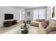 Bright living room with beige sofa, large window, and stylish glass coffee table at 5855 Valley Dr # 2020, North Las Vegas, NV 89031
