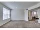 Bright living room featuring carpet, neutral walls and a large window at 5855 Valley Dr # 2020, North Las Vegas, NV 89031