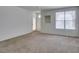 Bright living room with large windows and neutral carpet, ready for personal touches at 5855 Valley Dr # 2020, North Las Vegas, NV 89031