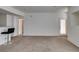 Open living space with a view towards the kitchen and access to the entryway at 5855 Valley Dr # 2020, North Las Vegas, NV 89031