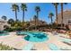 Community pool area with lots of seating, palm trees and lush landscaping create a relaxing atmosphere at 5855 Valley Dr # 2020, North Las Vegas, NV 89031