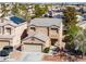 Aerial view of a two-story home with a two-car garage and solar panels at 6120 Crystal Cascade St, Las Vegas, NV 89130