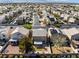 Aerial view of a home featuring a charming backyard, desert landscaping, and solar panels on nearby rooftops at 6120 Crystal Cascade St, Las Vegas, NV 89130