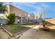Backyard featuring a covered patio, desert landscaping, brick borders and a privacy wall at 6120 Crystal Cascade St, Las Vegas, NV 89130