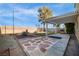 Spacious backyard with a pergola, stone pathway, desert landscaping, and privacy wall at 6120 Crystal Cascade St, Las Vegas, NV 89130