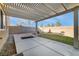 Large backyard featuring a covered patio, brick wall, and desert landscaping at 6120 Crystal Cascade St, Las Vegas, NV 89130