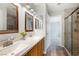 Bathroom with double sinks, a glass shower, and a large closet at 6120 Crystal Cascade St, Las Vegas, NV 89130