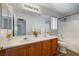 Bathroom featuring double sinks, vanity, and tub-shower combo for comfortable living at 6120 Crystal Cascade St, Las Vegas, NV 89130