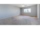 Spacious bedroom with neutral carpet and a large window providing ample natural light at 6120 Crystal Cascade St, Las Vegas, NV 89130