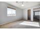 Bright, neutral bedroom features a ceiling fan, window, and a closet, offering ample storage at 6120 Crystal Cascade St, Las Vegas, NV 89130