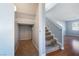 Hallway view features a storage nook, a staircase, and hardwood flooring at 6120 Crystal Cascade St, Las Vegas, NV 89130
