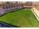 Expansive backyard featuring a lush lawn, retaining wall, mature trees, and landscape for outdoor enjoyment at 6197 Jewel Vista St, Las Vegas, NV 89135