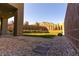 Spacious backyard featuring desert landscaping, manicured trees, and a distant mountain view at 6197 Jewel Vista St, Las Vegas, NV 89135