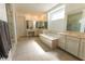 Bright bathroom with a soaking tub, and tile flooring at 6197 Jewel Vista St, Las Vegas, NV 89135