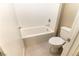 Compact bathroom area showing white bathtub, ceramic tile, showerhead and white toilet at 6197 Jewel Vista St, Las Vegas, NV 89135