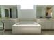 Bathroom featuring a large soaking tub, and dual vanities at 6197 Jewel Vista St, Las Vegas, NV 89135