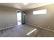Cozy bedroom with natural light, gray carpet, and access to a private balcony through glass doors at 6197 Jewel Vista St, Las Vegas, NV 89135