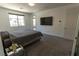 Cozy bedroom with a large window, tv and gray bed at 6197 Jewel Vista St, Las Vegas, NV 89135