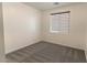 Comfortable bedroom with a modern horizontal window shade, plush gray carpet, and neutral wall paint at 6197 Jewel Vista St, Las Vegas, NV 89135