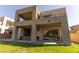 Modern home exterior with multiple balconies, a covered patio, and well-maintained lawn at 6197 Jewel Vista St, Las Vegas, NV 89135